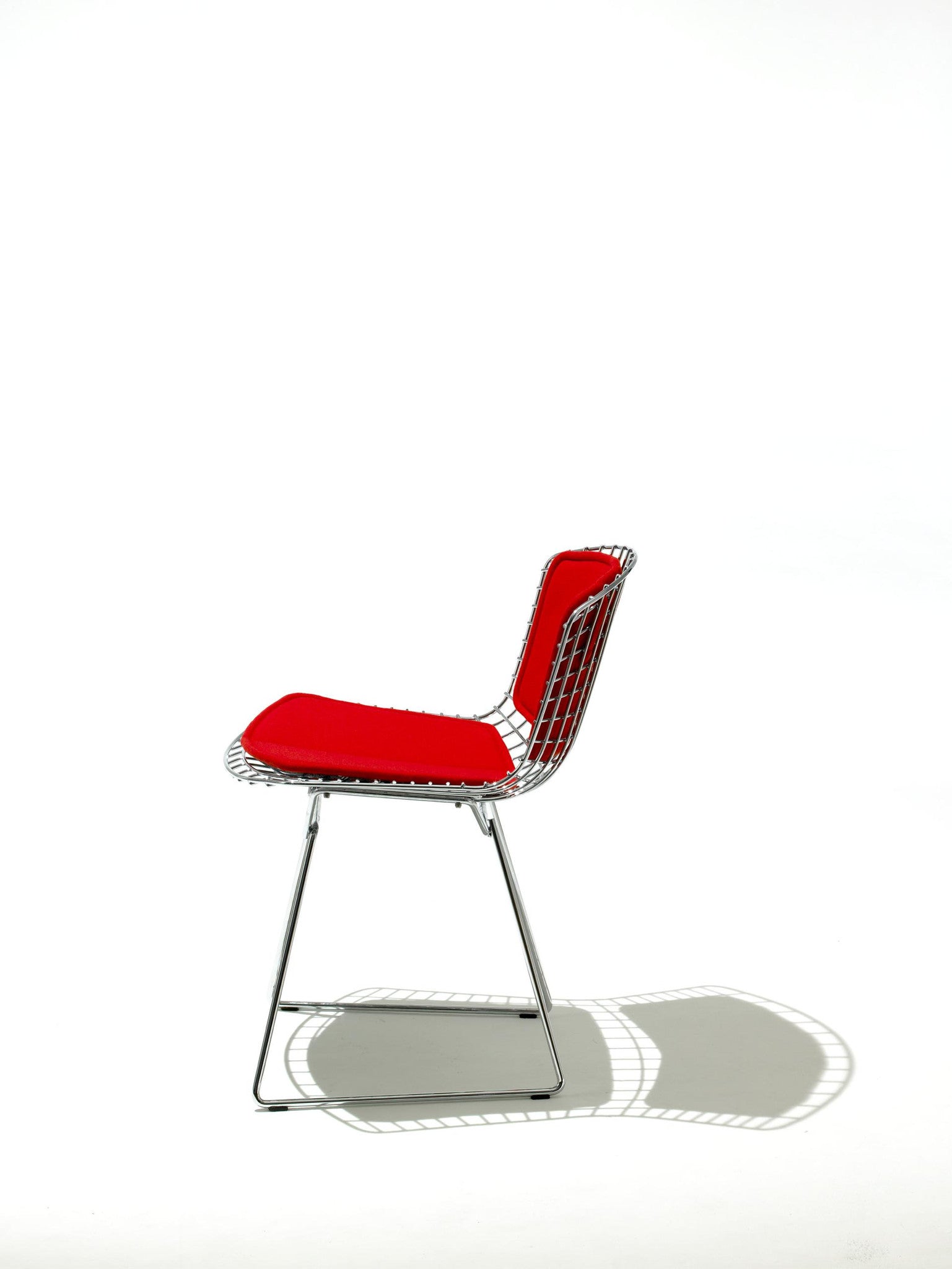 Bertoia Side Chair in chrome with a red seat and back pad