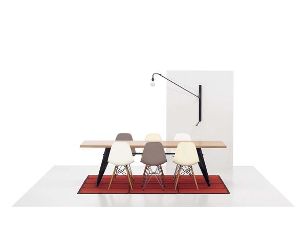 EM table with natural oak and black base legs surrounded by Eames DSW and DSR chairs